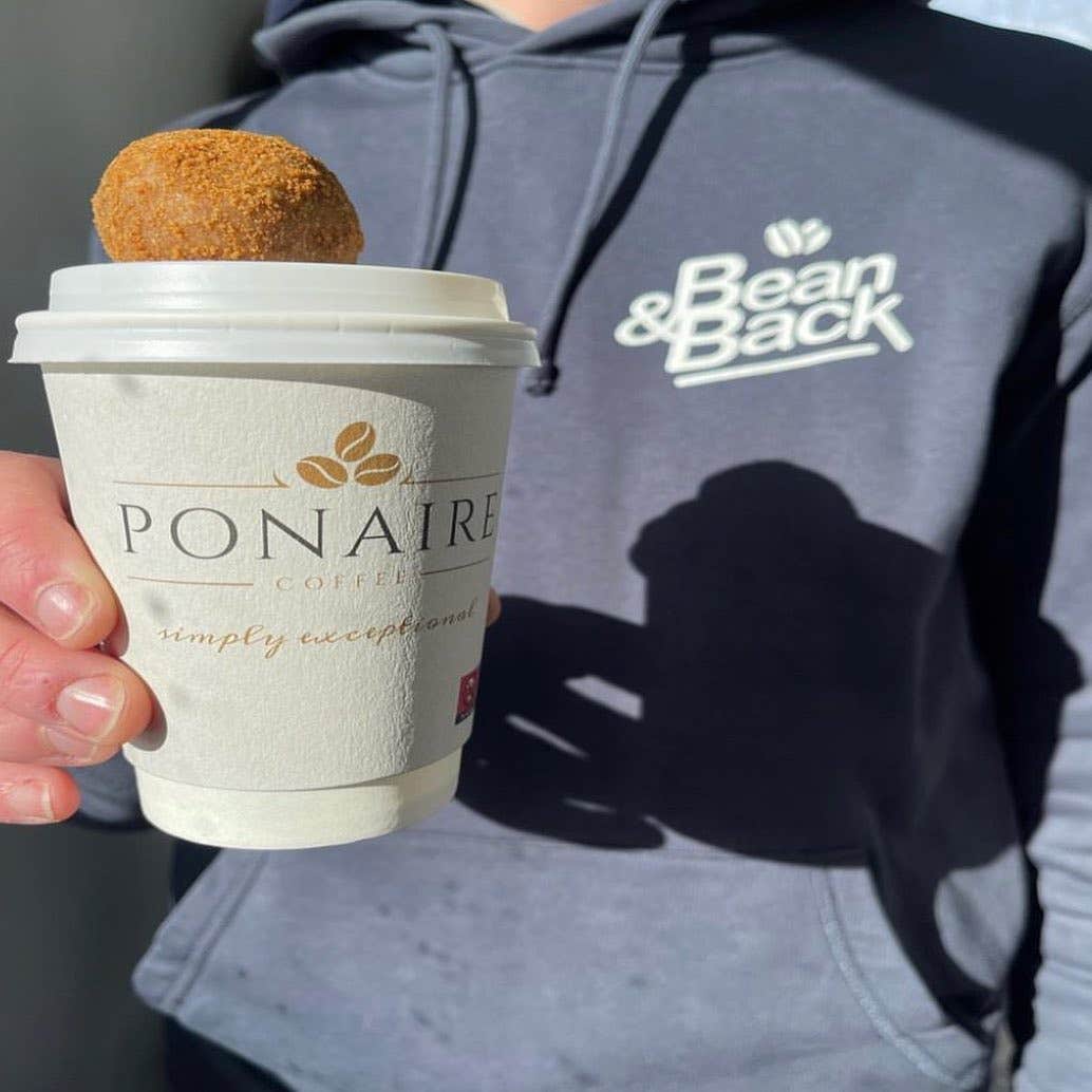 A man holding a cup of coffee from Ponaire Lorge in Adare, County Limerick.