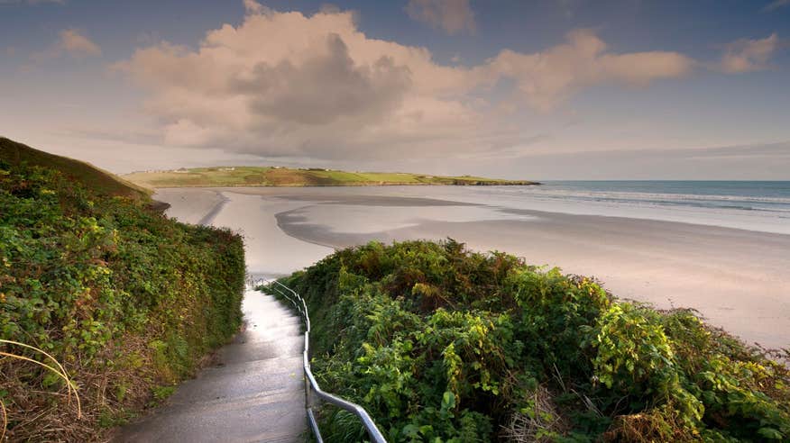 A path leading towards Inchydoney Beach in Cork at sunset
