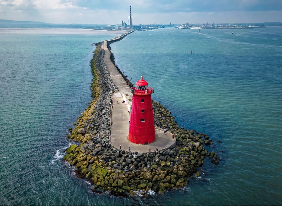 Dublin Bay Bicycle Tour aerial view of the red Poolbeg Lighthouse in the middle of the sea