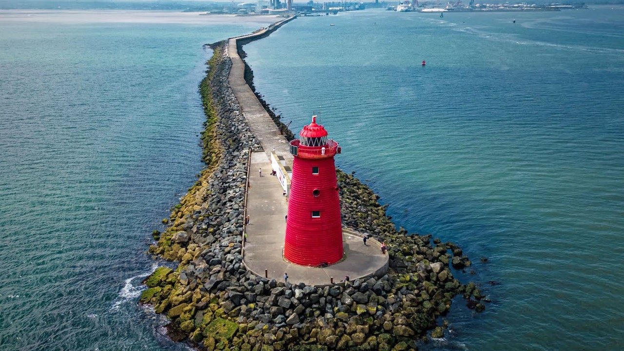 Dublin Bay Bicycle Tour aerial view of the red Poolbeg Lighthouse in the middle of the sea