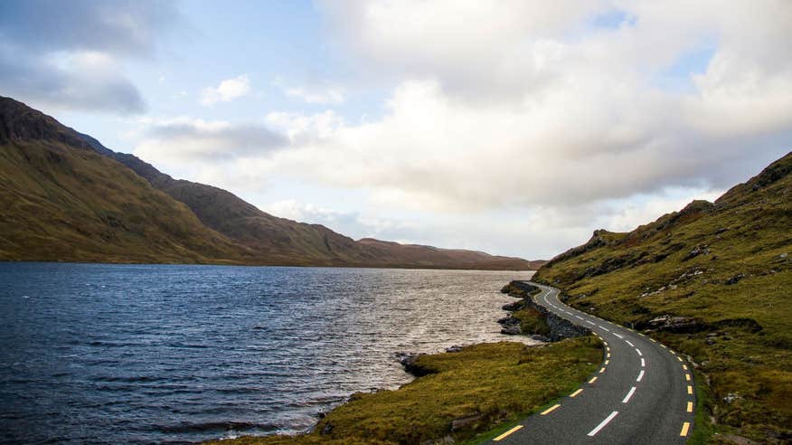 A road beside a body of water in the Doolough Valley, Mayo