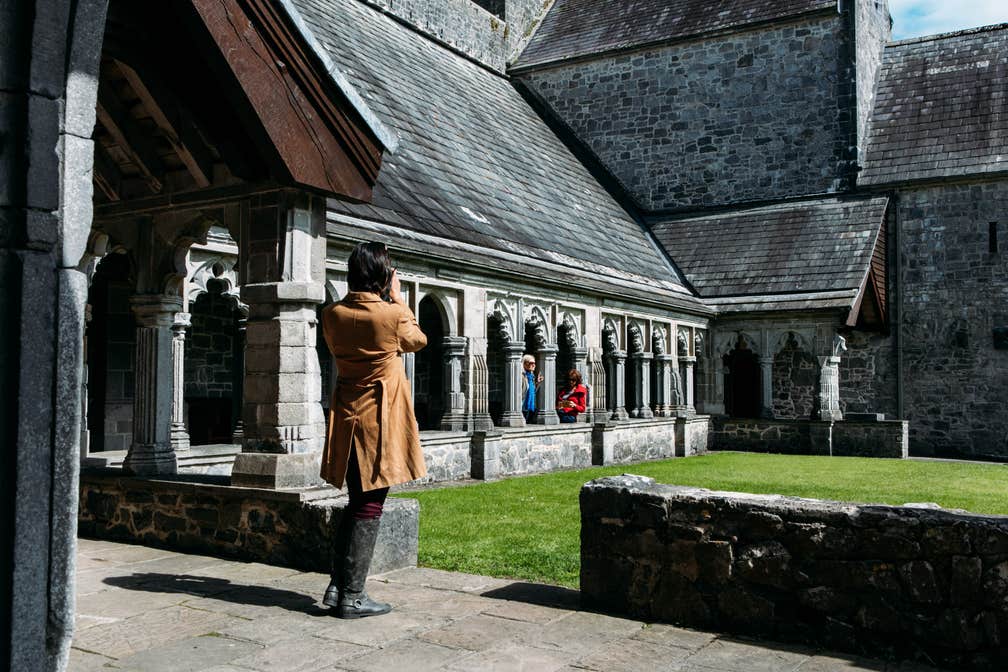 Woman taking a photo at Holycross Abbey.