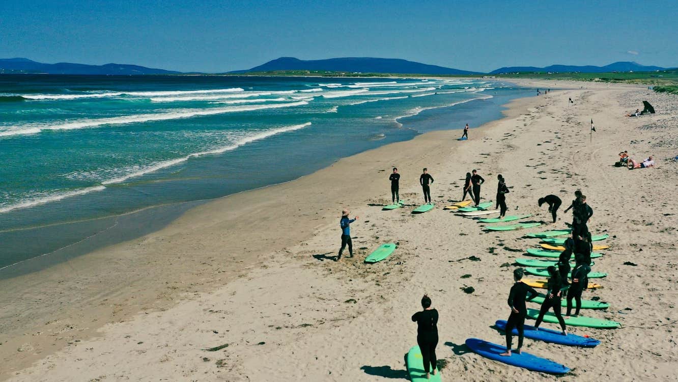 A group taking part in a surf lesson
