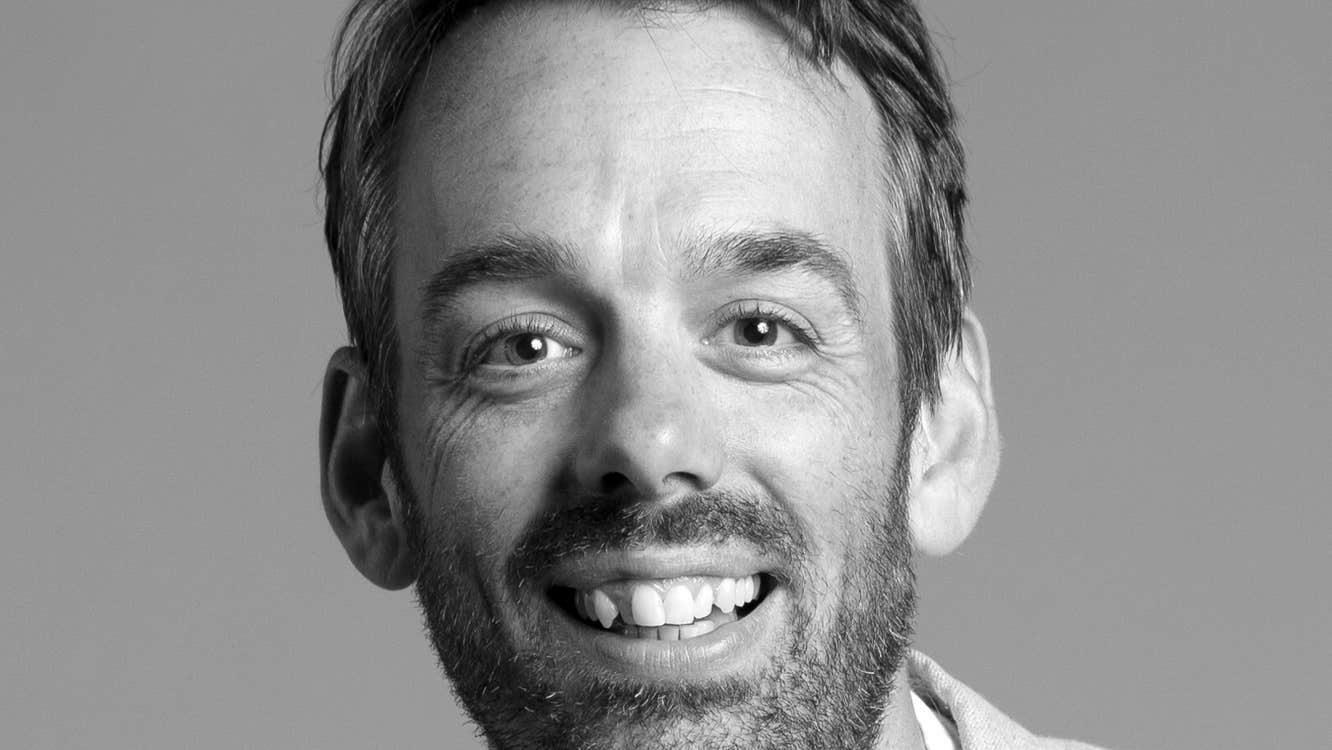 The head and shoulders of Chris Finnegan. He is smiling.