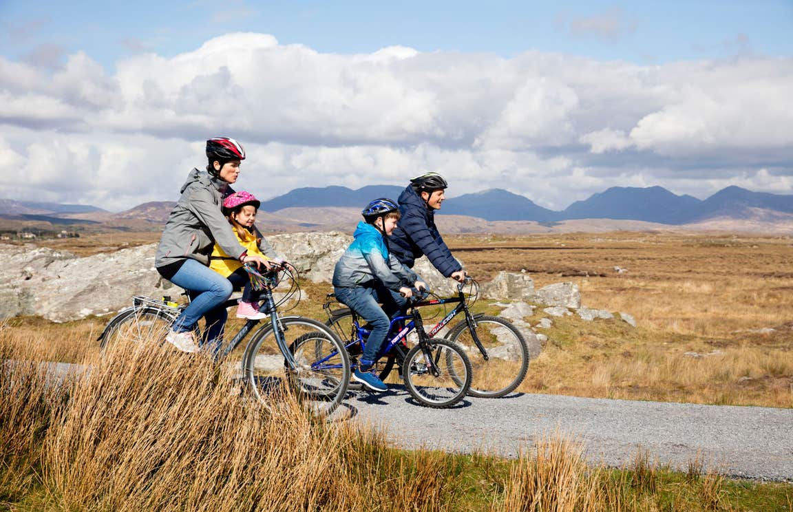Family cycling through Derrigimlagh, County Galway