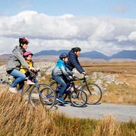 Family cycling through Derrigimlagh, County Galway