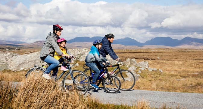 Family cycling through Derrigimlagh, County Galway
