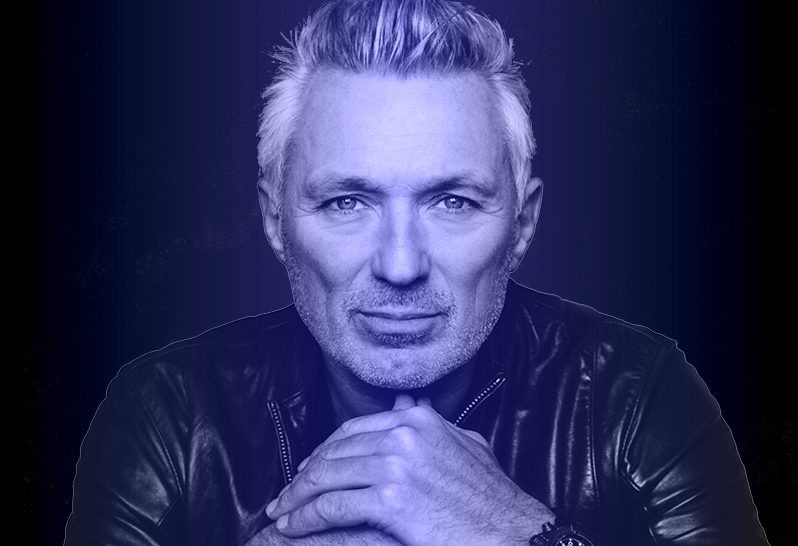Martin Kemp – Back To the 80’s DJ Set. Head and shoulders hot in black and purple hue of man looking directly at the camera.
