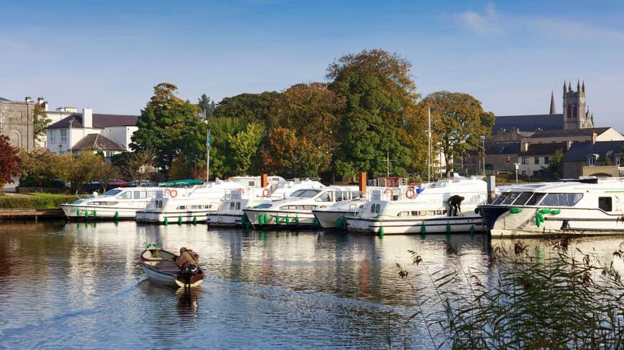 A small boat approaching bigger boats at Carrick-on-Shannon Marina, Co. Leitrim