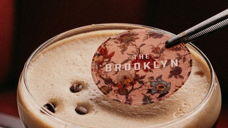 A cocktail decoration is added to the top of an espresso martini