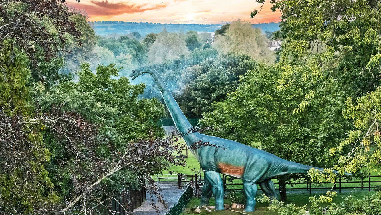 Jurassic Newpark aerial view of the park with a life size dinosaur model