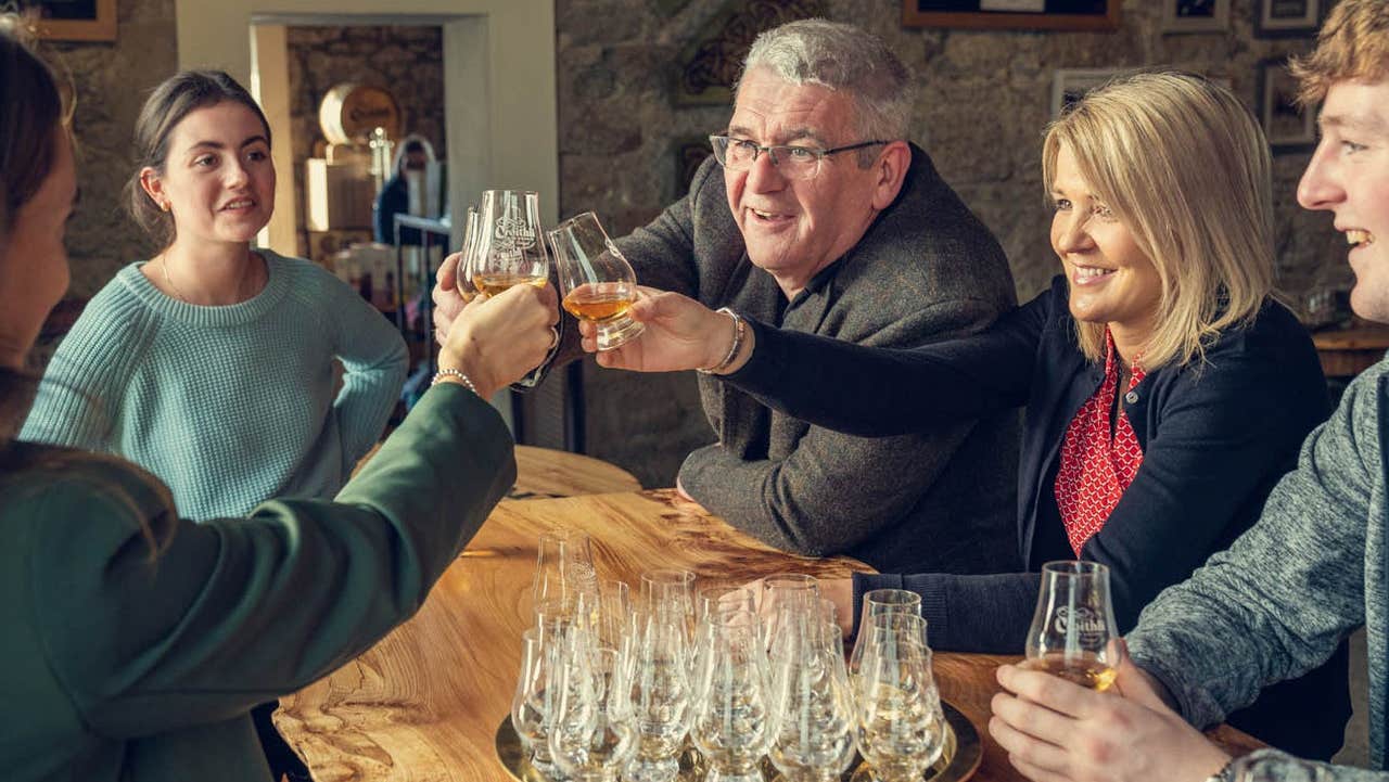 A group of people around a table tasting whiskey