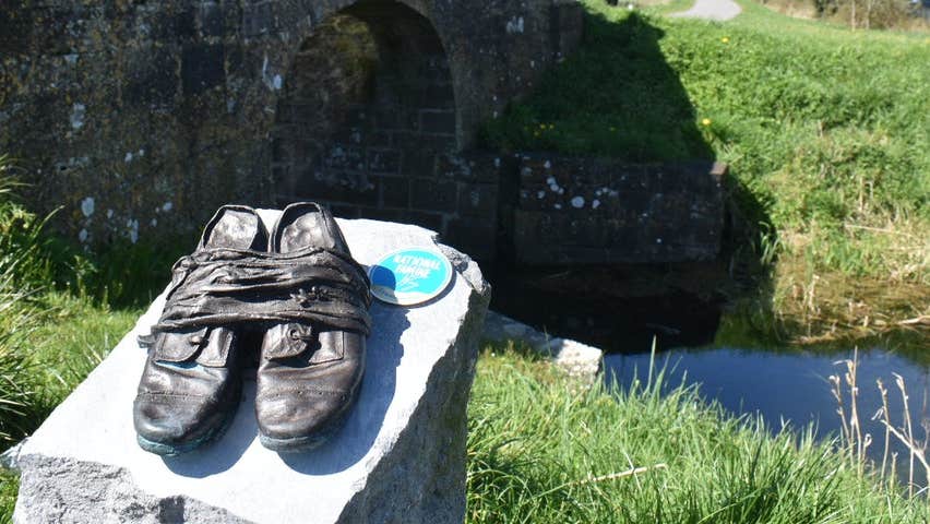 Bronze shoes sculpture along a walking route