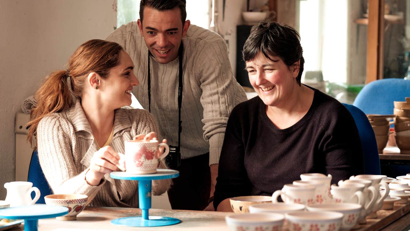 People chatting and admiring beautiful pottery
