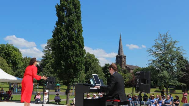 BVOF 2026 - Free Open Air Recital Dungarvan - A person playing a keyboard and a woman singing on a small stage in a park.