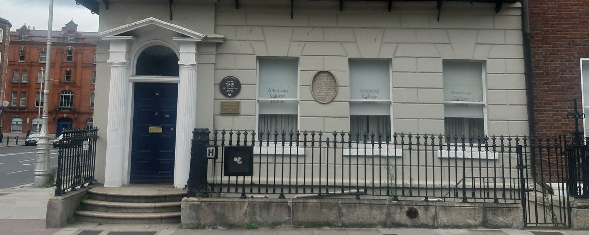 The exterior of a large period house on a street in Dublin