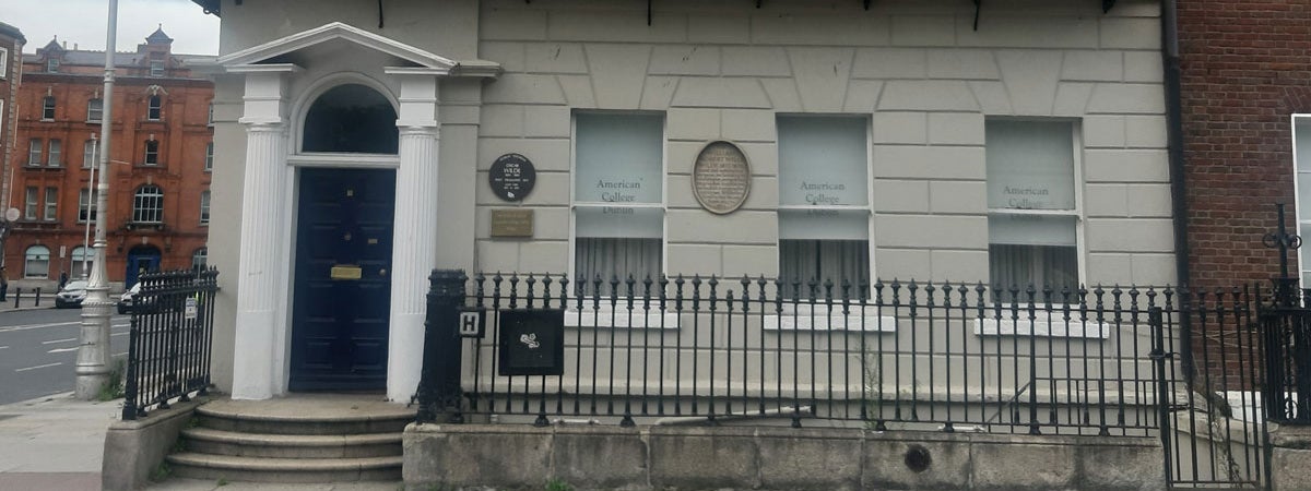 The exterior of a large period house on a street in Dublin