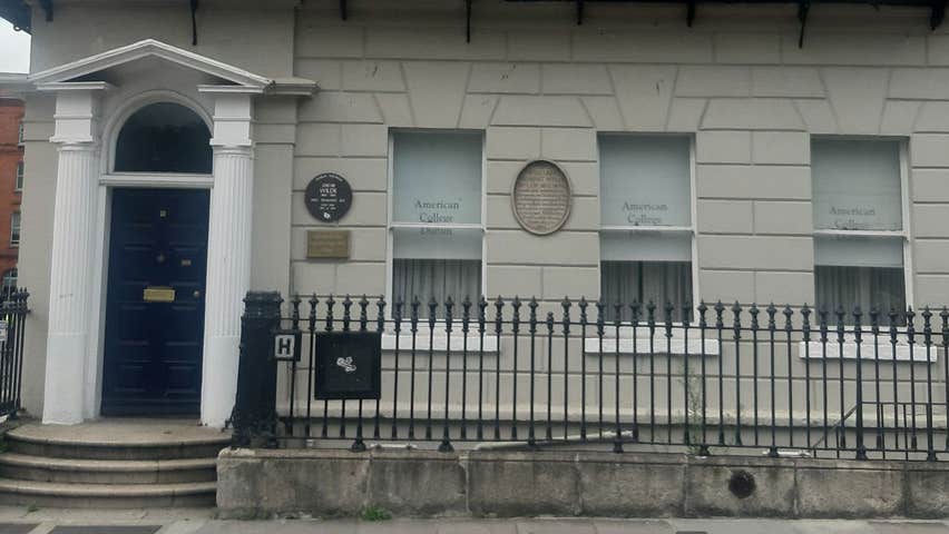 The exterior of a large period house on a street in Dublin