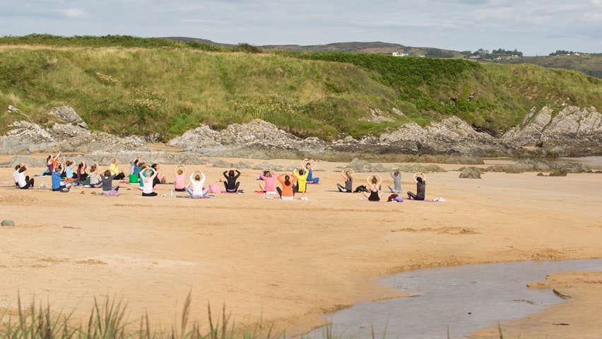 Yoga on the beach beside a stream at Inishowen Yoga Carndonagh County Donegal