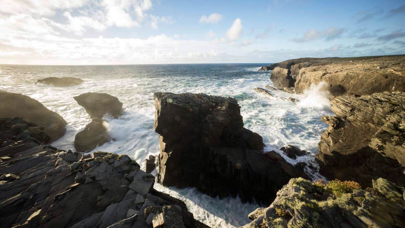 Waves from the Atlantic ocean crashing against cliffs at Dún na mBo in County Mayo.