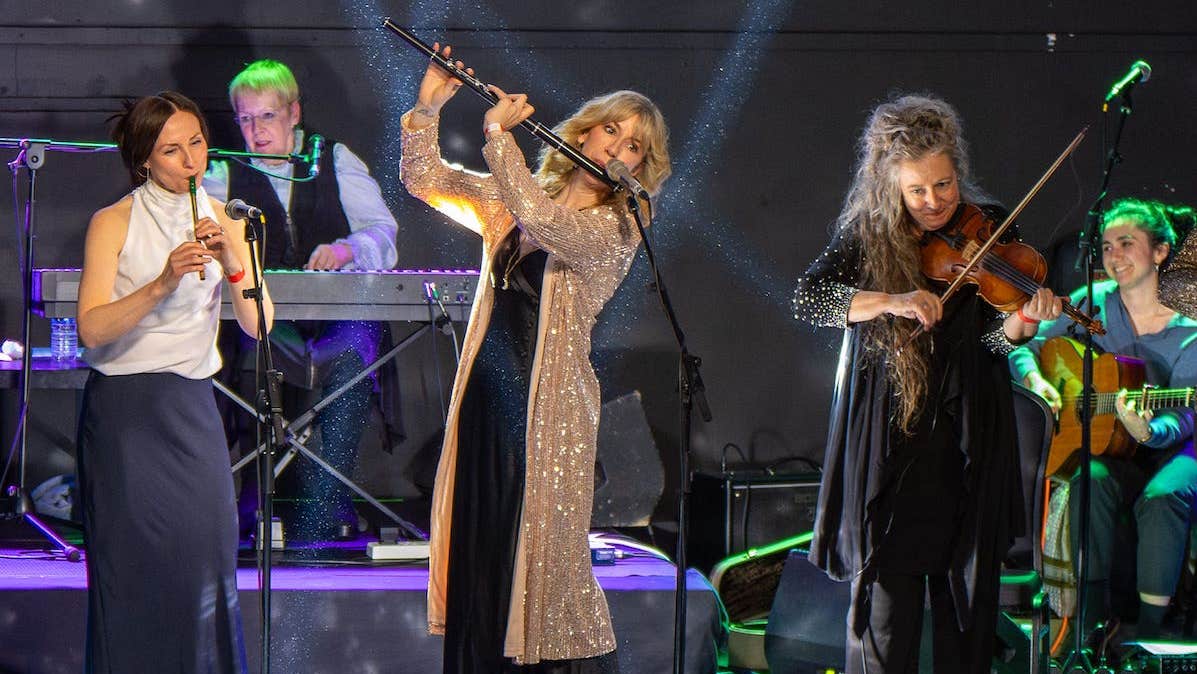 Women on a stage playing musical instruments
