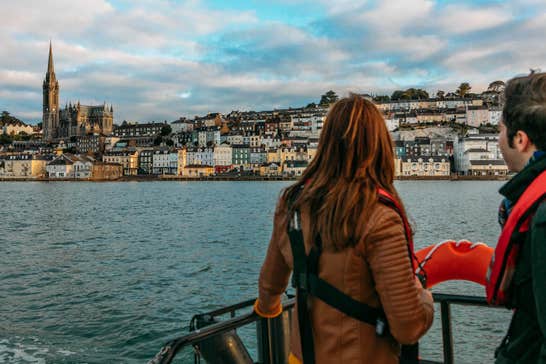 A couple looking out at Cobh in County Cork from a boat