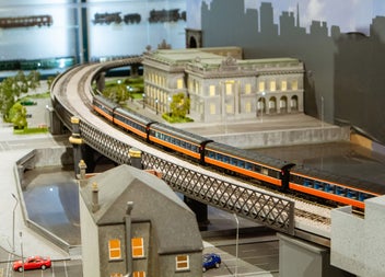Model of a train station and a train going by on the track 
