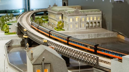 Model of a train station and a train going by on the track 