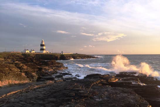 Sunset at Hook Head in Wexford with a lighthouse in the distance