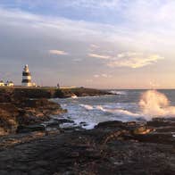 Sunset at Hook Head in Wexford with a lighthouse in the distance