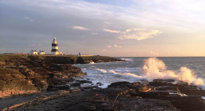 Sunset at Hook Head in Wexford with a lighthouse in the distance