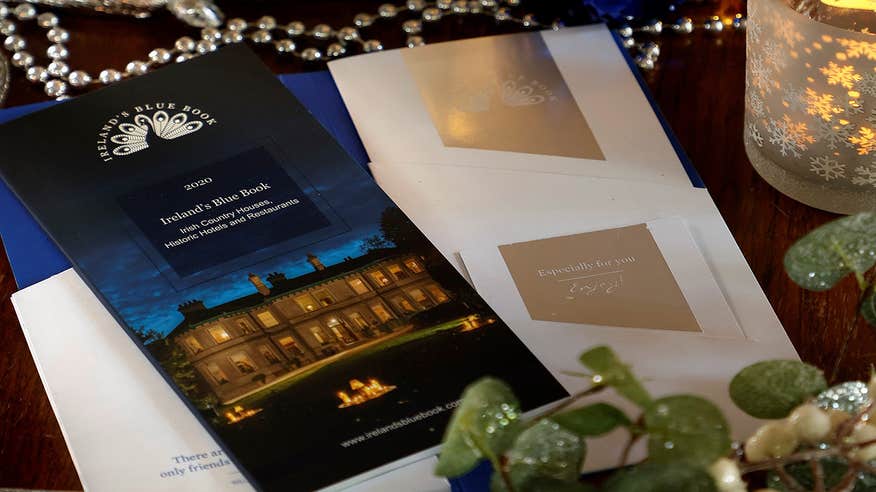 Ireland Blue Book Voucher surrounded by candles and glitter