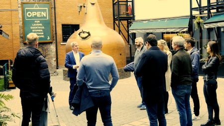 A group by whiskey stills on a tour