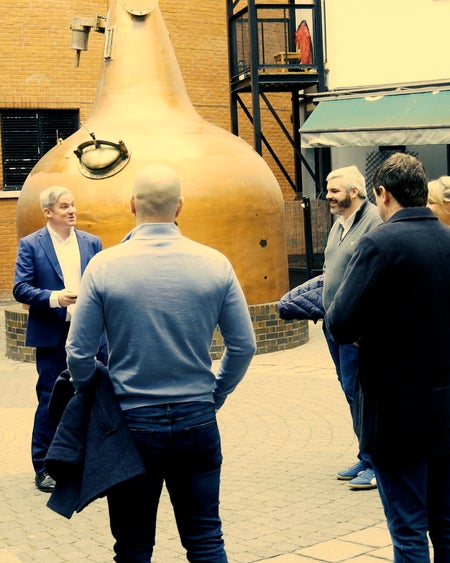 A group by whiskey stills on a tour