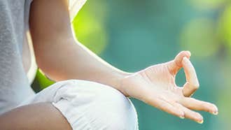 Dublin Mind Body Experience - partial view of person seated crossed legged resting upward facing hand on knee