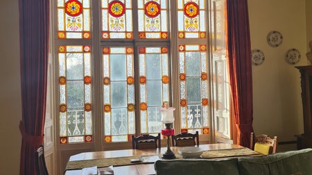 A large room with antique furniture and large stained glass windows