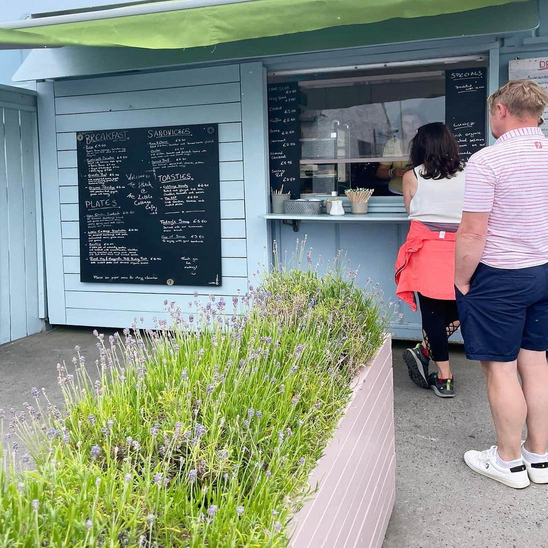 Two people ordering from the hatch at the Little Cottage Café in Rosses Point in County Sligo.