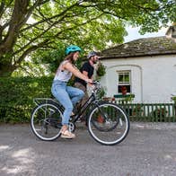 Couple cycling along the Royal Canal Greenway.