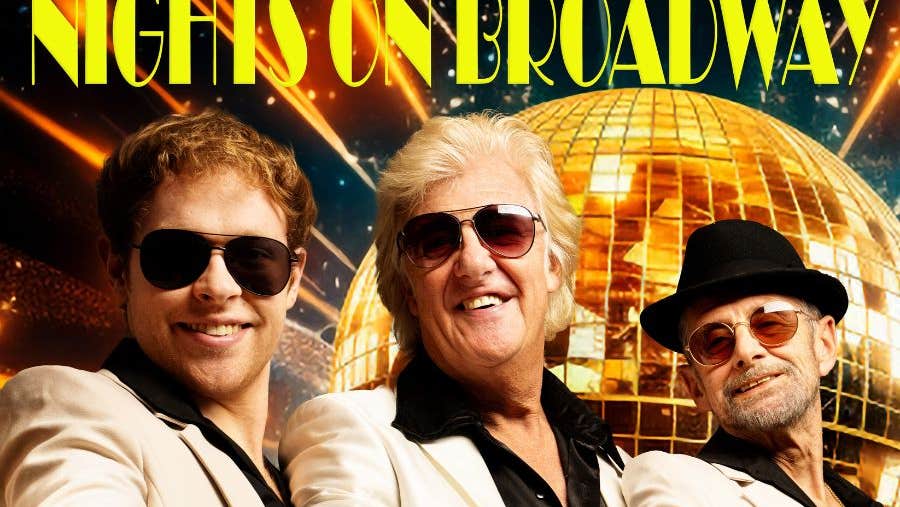 3 smiling men in white suits and dark shirts, all wearing sunglasses with gold, mosaic disco ball in background.