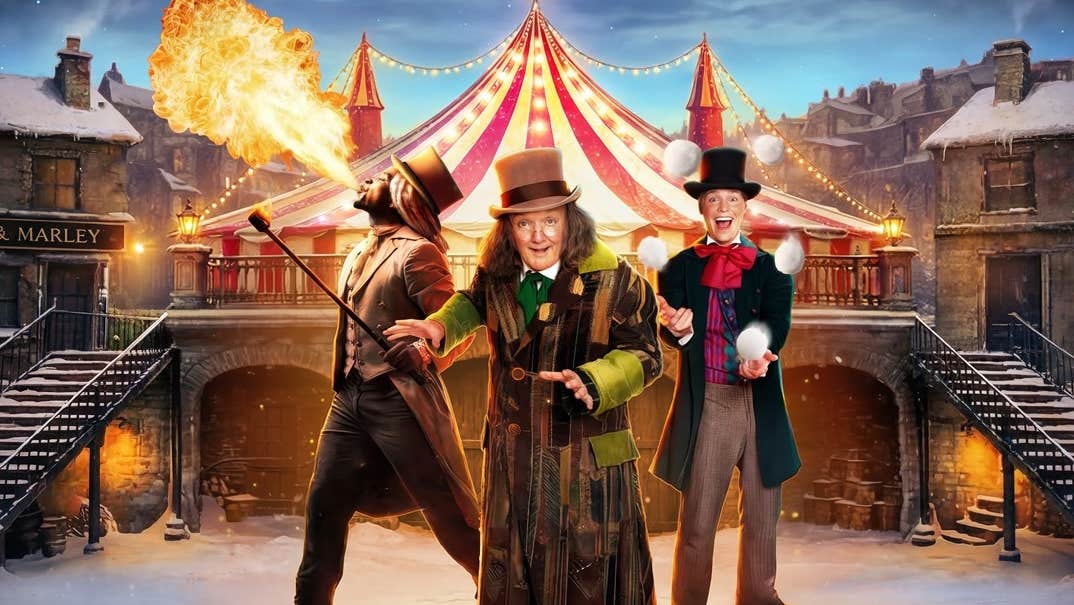 Scrooge: A Cirque Spectacular at Gleneagle, 3 performers in different costumes with hats, with roof of circus tent behind in winter with snow on the ground.