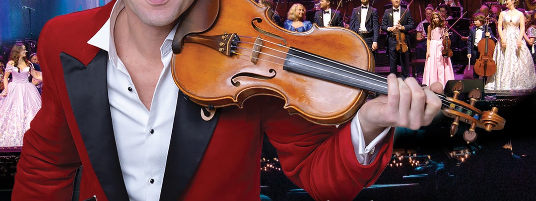 Vladimir's Christmas Spectacular 2025, a smiling man holding a violin under his neck, on left shoulder.