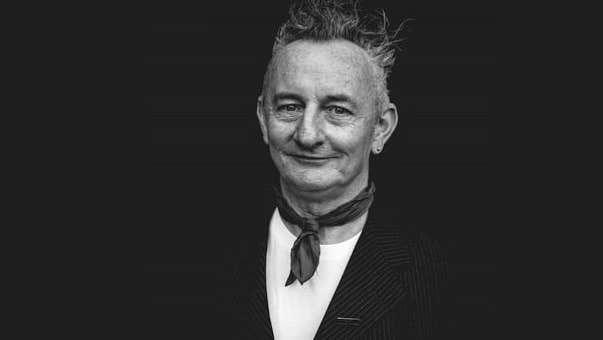 Writer & theatre maker Little John Nee, a smiling man with small neckerchief around his neck