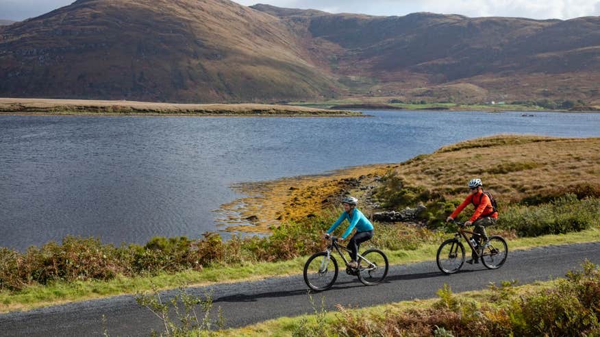 Two people cycling along the Great Western Greenway, County Mayo by water