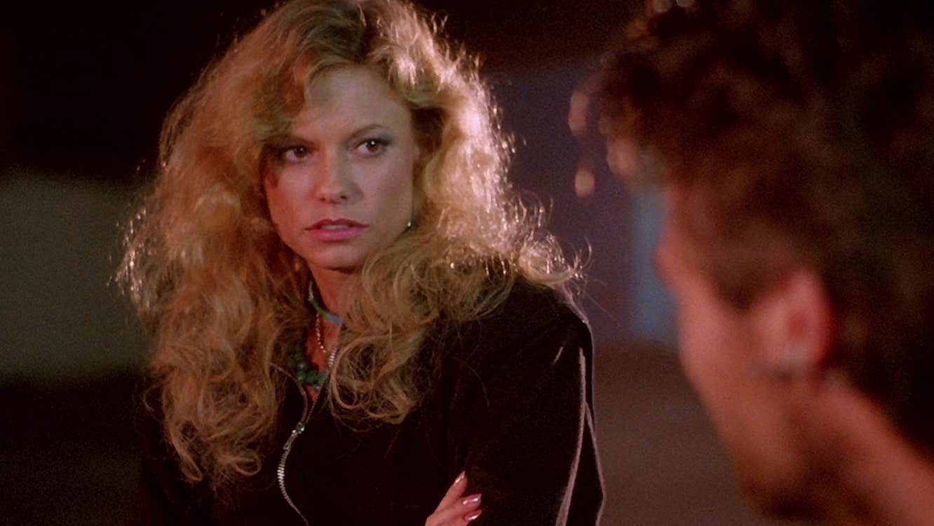 A woman with a wary expression is looking at a man.