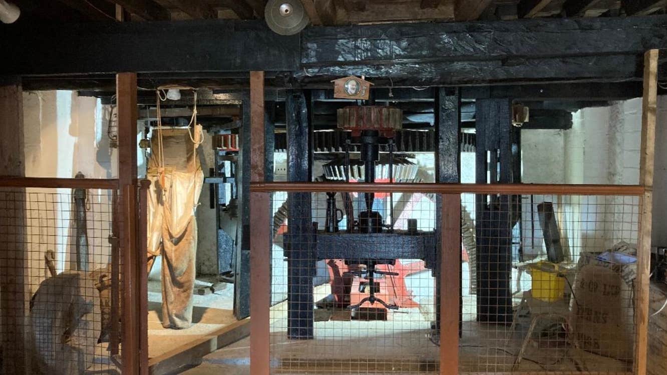 The interior of Craanford Mills with the restored water wheel in the middle
