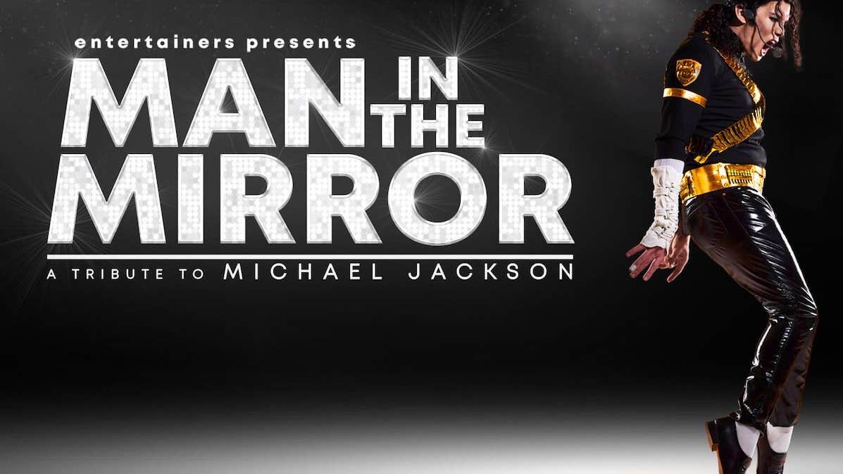 Man in the Mirror, A Tribute to Michael Jackson. A man dressed in black in a dance pose on his toes with arms behind and mouth wide open.