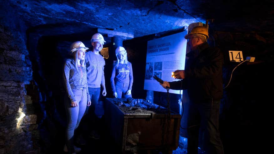 Four people hard hats on an underground tour in the Arigna Mines in Roscommon.