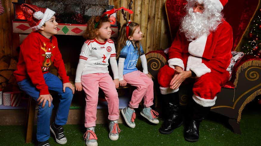 Man dressed as Santa speaks with children at the GAA Museum in Croke Park.