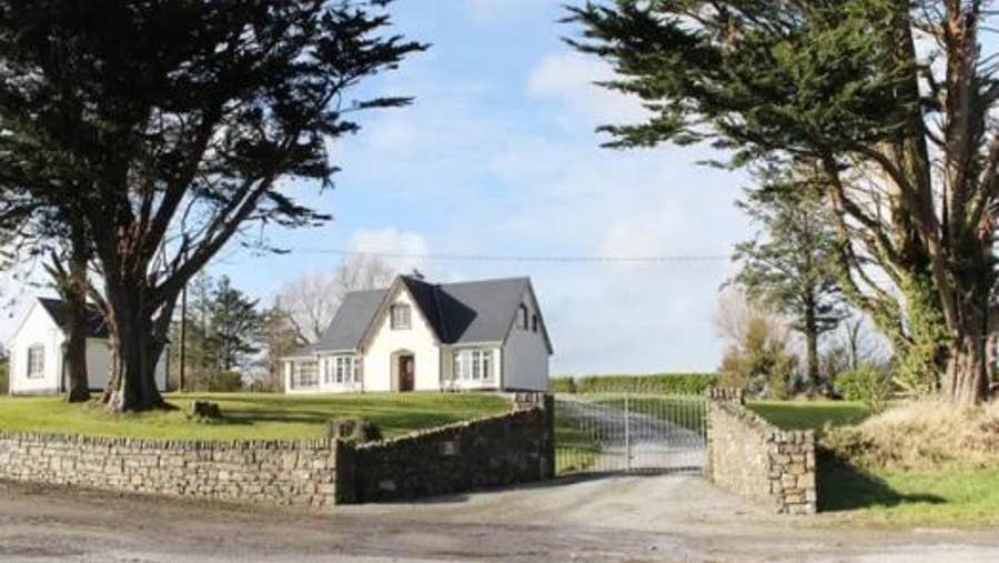 Exterior of house with mature trees in the garden