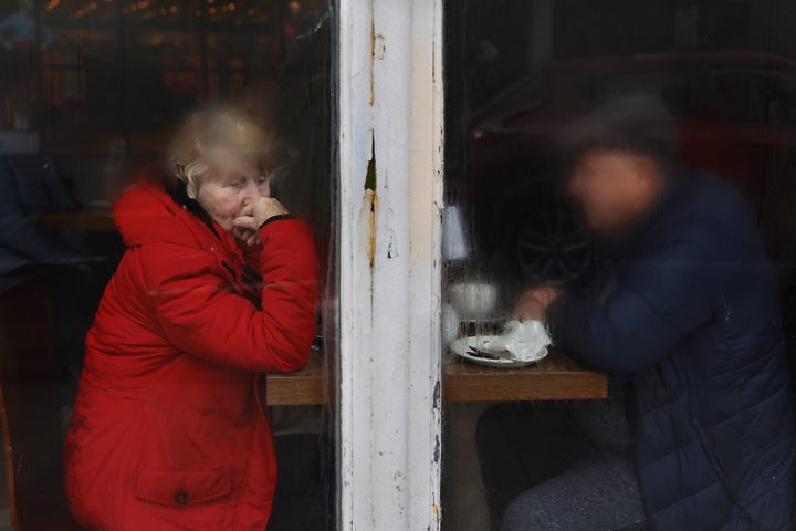 Elderly couple sitting on other side of window, half fogged, drizzly morning, man obscured by condensation and woman stares out of frame to the bottom right. Copyright David Stephenson.